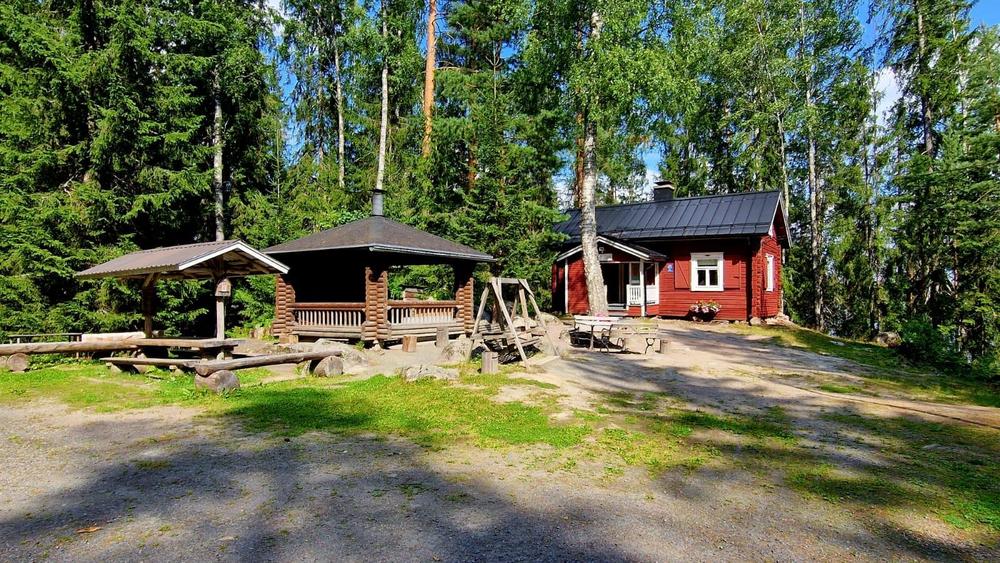 Kiviniemen kesämaja. Edustalla on grillikatos ja pihakeinu.