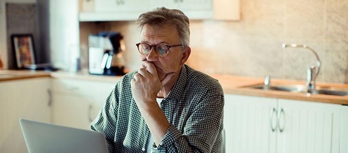 A man sitting with a kitchen in the background