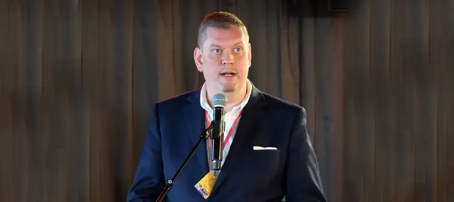 Jouni Parkkonen puhumassa mikrofoniin.