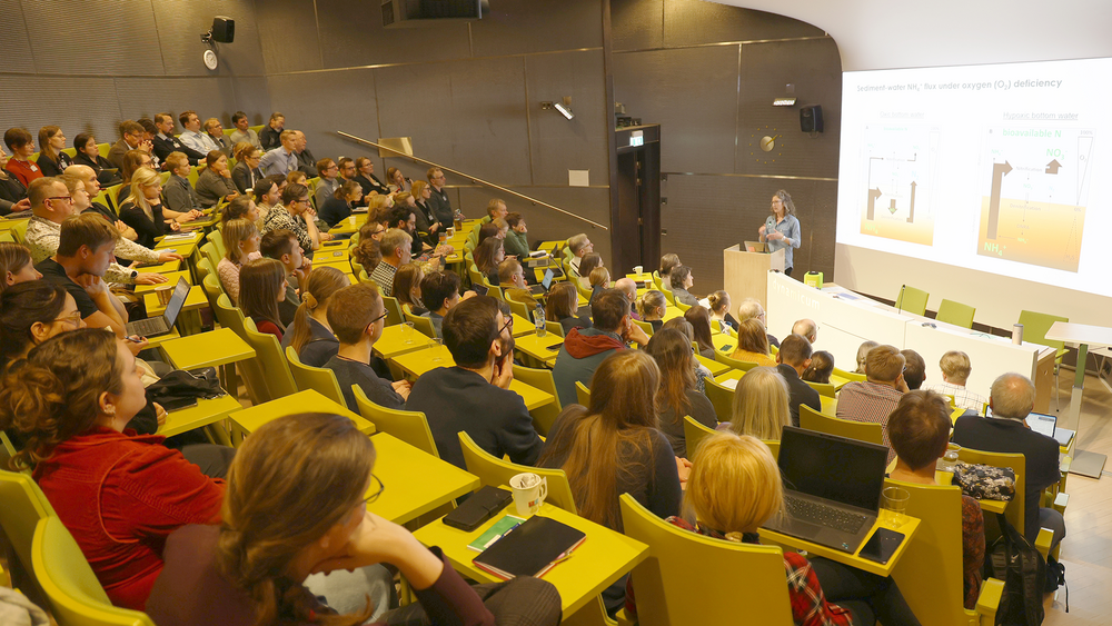 Auditorium full of people listening to a presentation