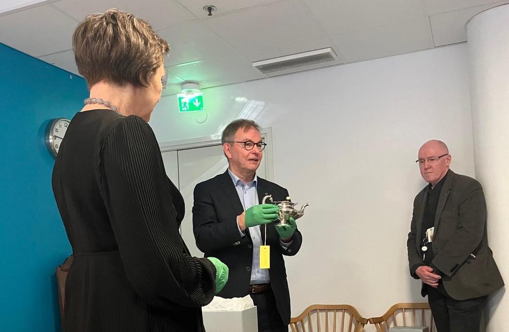 Puheenjohtaja Maijala (keskellä) ojentamassa Ystävien lahjoitusta Suomen Kansallismuseon ylijohtaja Elina Anttilalle (vasemmalla) Vantaan Kokoelmakeskuksessa 22.3. Kokoelmaintendentti Jouni Kuurne (oikealla) oli ehdottanut kannun hankintaa , ja kertoi sen taustasta. 