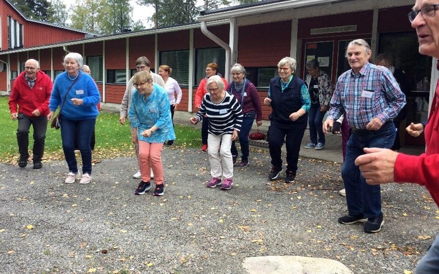 Eläkeläisiä jumppaamassa ulkona yhdessä